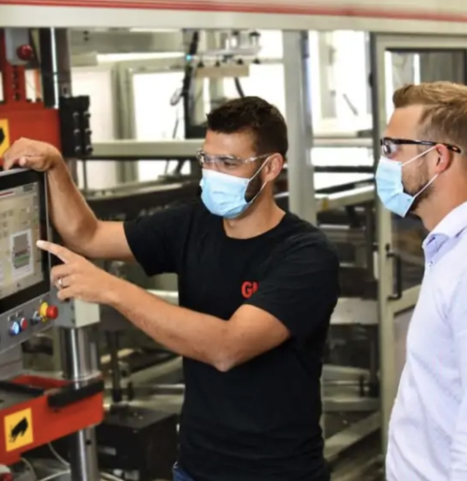 Two men looking at packaging technology system
