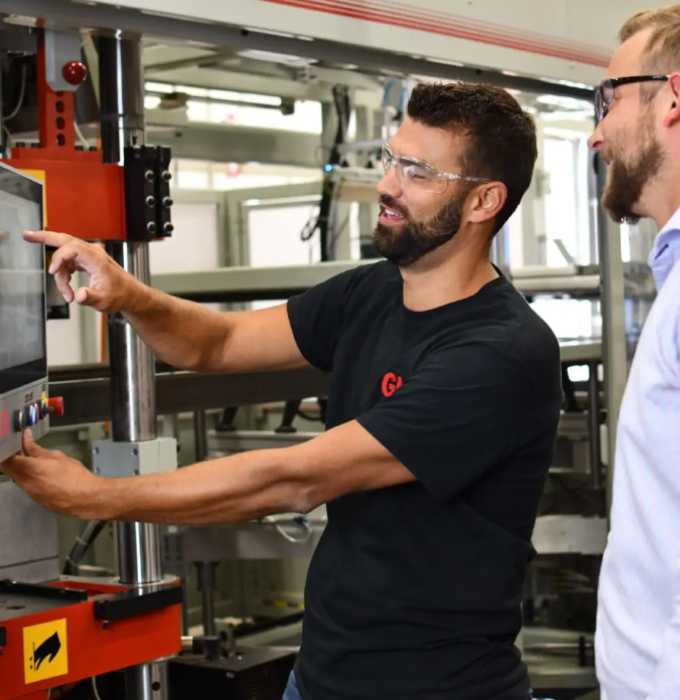Two men looking at packaging technology system