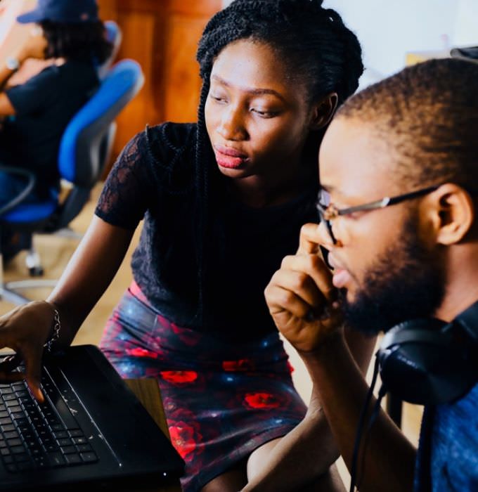 Two employees looking at computer